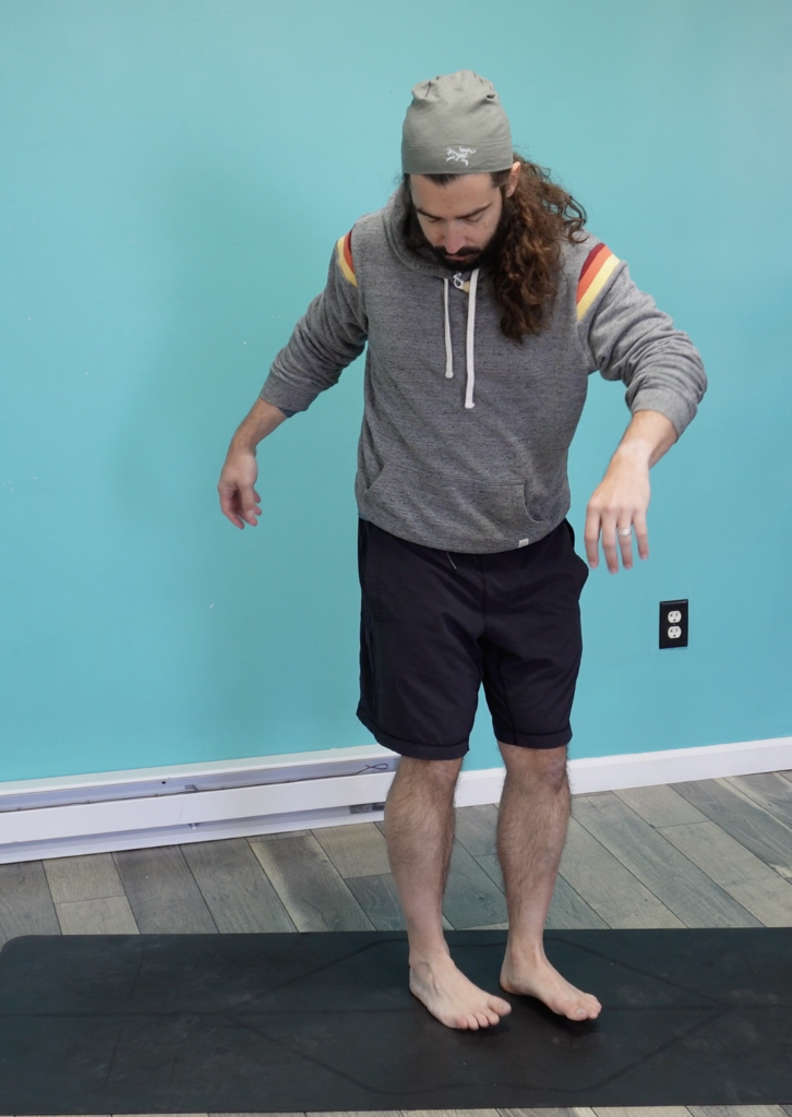 John demonstrating heel toe slides to strengthen feet and ankles